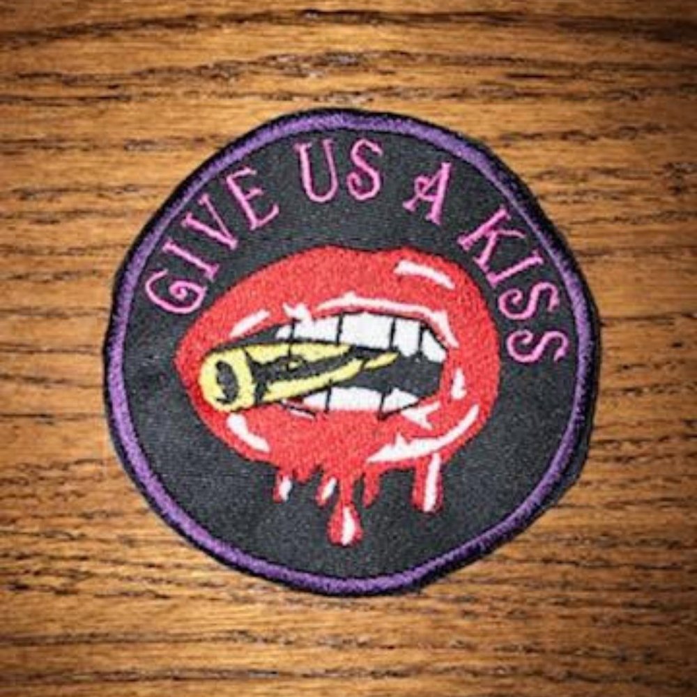 Embroidered Give Us a Kiss Dripping Lips biting a bullet patch/emblem
